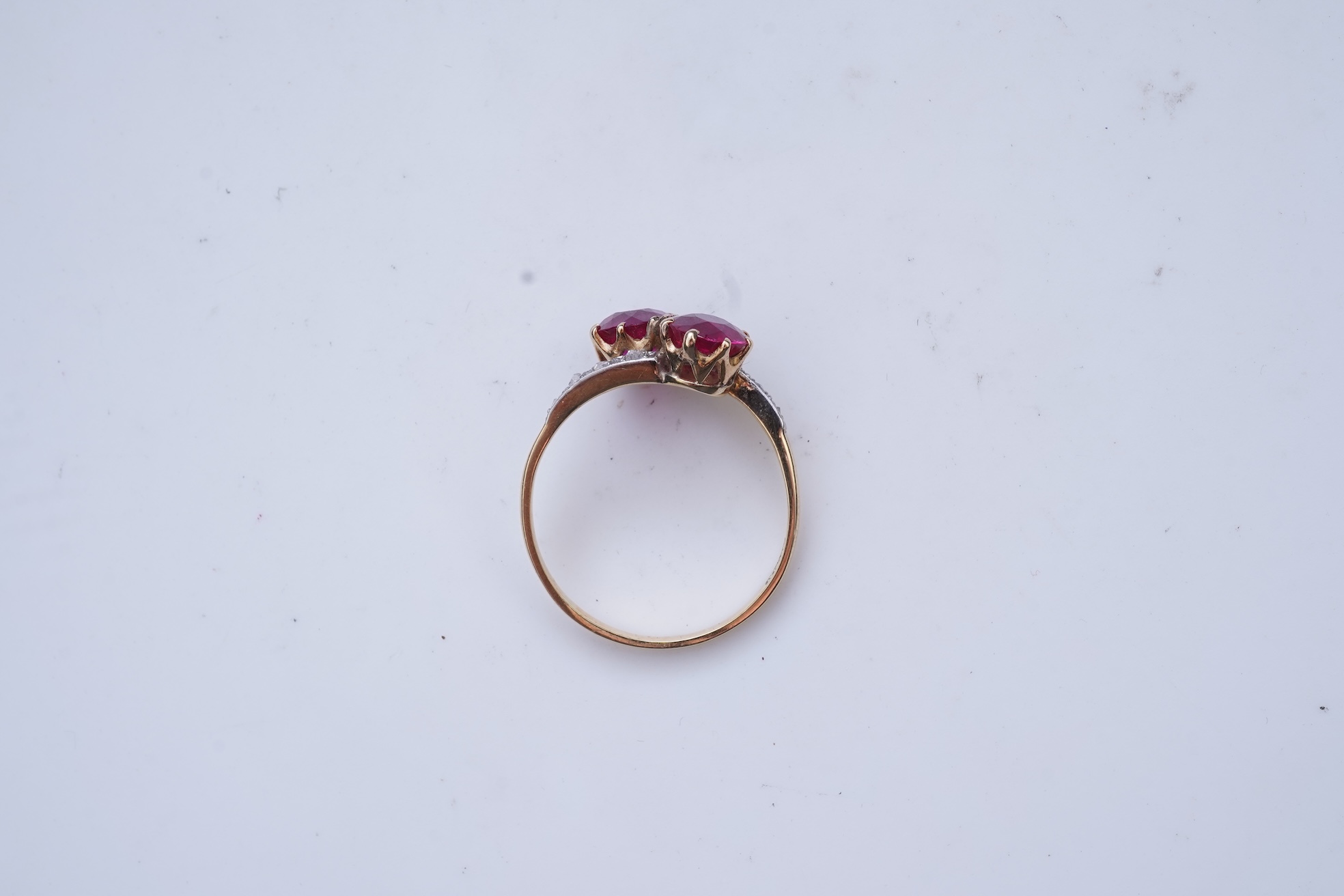 A synthetic ruby and diamond 'toi-et-moi' ring, early 20th century
